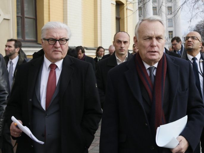 German Foreign Minister Frank-Walter Steinmeier (L) and French Foreign Minister Jean-Marc Ayrault walk along a street before attending a news conference in Kiev, Ukraine, February 23, 2016. Steinmeier said on Tuesday that reform efforts in Ukraine must not now flag and come to a standstill halfway through. REUTERS/Valentyn Ogirenko