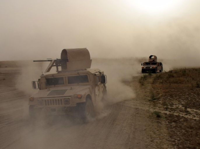 FILE - Iraqi army Humvees race toward the front lines on the outskirts of Ramadi during heavy clashes with Islamic State group militants in this Sept. 12, 2015, file photo. The fighting eventually led to the recapture of the city from the extremists. After the massive destruction wreaked on Ramadi, Iraqi and coalition officials are rethinking tactics as they prepare for an assault to retake the biggest IS-held prize, the northern city of Mosul. (AP Photo, File)