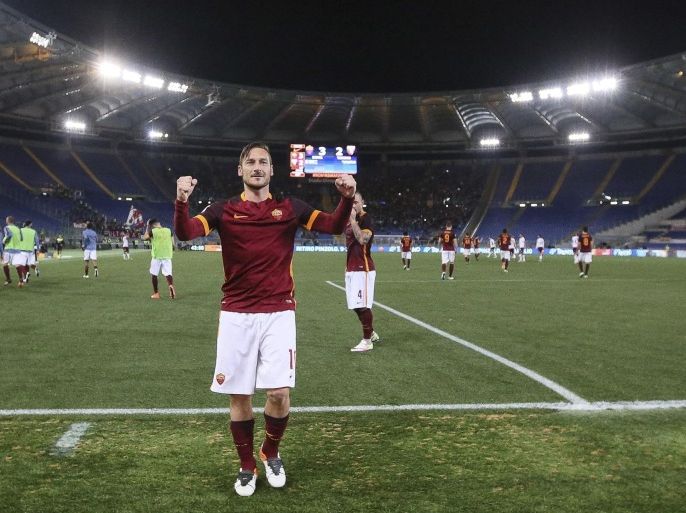Roma's Francesco Totti, center, celebrates after scoring the winning goal during a Serie A soccer match between Roma and Torino at Rome's Olympic stadium, Wednsday, April 20 April 2016. Approaching his 40th birthday, Totti came off the bench to score two late goals in Roma's 3-2 comeback win over Torino on Wednesday amid intense debate over his future with the only club he's ever played for. (Alessandro Di Meo/ANSA via AP)