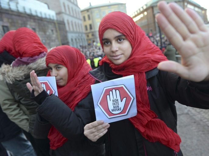 Two young girls carrying leaflets reading 'don't touch my mosque' participate in a demonstration at the house of parliament in Stockholm, Sweden, 02 January 2015. Police have tightened security around some of Sweden's main mosques, after the mosque suffered a firebomb attack a day earlier, one of three arson attacks targeting the muslim community in Sweden since Christmas Day. EPA/FREDRIK SANDBERG SWEDEN OUT