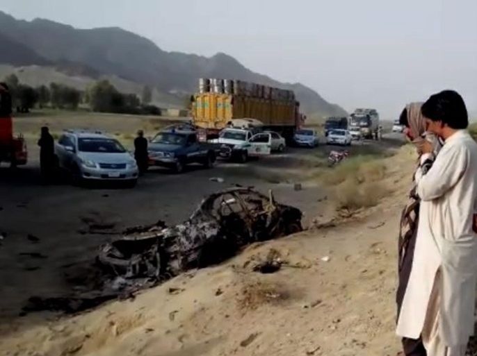 A frame grab from a video made available on 22 May 2016 shows people watch the wreckage of a vehicle at the alleged scene of a drone strike site that killed Taliban's supreme leader Mullah Akhtar Mansoor, in the Ahmad Wal area of Balochistan in Pakistan. Dawlat Waziri, Afgan Defense Ministry spokesman confirmed to the reporters that Taliban's supreme leader Mullah Akhtar Mansoor was killed in Balochistan province of Pakistan. Mullah Akhtar Mansoor took over the comman