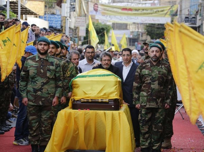 Hezbollah members and Hezbollah senior Lebanese Minister Hussein Hajj Hassan (CR) and Anan brother of Mustafa Badreddine (C) carry the coffin of top Hezbollah commander Mustafa Badreddine during his funeral in the southern suburb of Beirut, Lebanon, 13 May 2016. Badreddine, who was considered Hezbollah's most senior military commander, was killed in an attack in Syria.