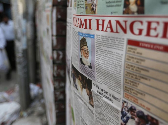 Bangladeshi men walk past newspapers, pasted on a wall which has news of the execution of Jamaat-e-Islami party chief Motiur Motiur Rahman Nizami, in Dhaka, Bangladesh, Wednesday, May 11, 2016. The head of Bangladesh's largest Islamist party was executed early Wednesday for his role in acts of genocide and war crimes during the country's independence war against Pakistan in 1971, a senior government official said. (AP Photo)