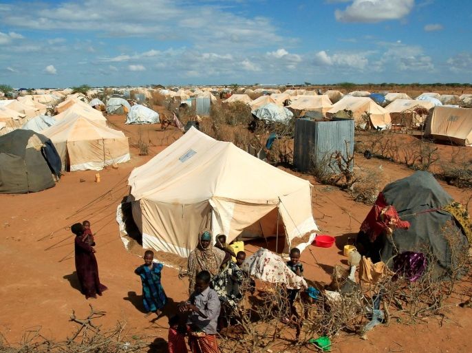 Refugees stand outside their tent at the Ifo Extension refugee camp in Dadaab, near the Kenya-Somalia border in Garissa County, Kenya October 19, 2011. REUTERS/Thomas Mukoya/File Photo