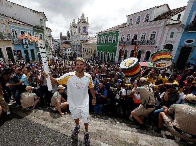 Brazilian paratriathlon athlete Marcelo Collet takes part in the Olympic Flame torch relay in Salvador, Brazil, May 24, 2016. Marcos de Paula/Courtesy of Rio2016/Handout via REUTERS ATTENTION EDITORS - THIS PICTURE WAS PROVIDED BY A THIRD PARTY. FOR EDITORIAL USE ONLY.