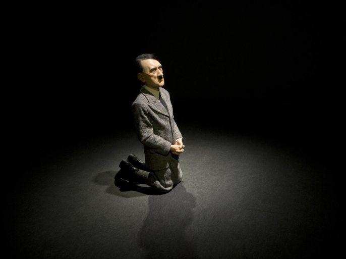 In this Friday, April 29, 2016 photo, "Him" Maurizio Cattelan is on display during the press preview of "Bound to Fail" at Christie's auction house in New York. Christie’s starts off the auction week on Sunday, May 8, with a themed sale titled “Bound to Fail,” that features the controversial sculpture of a praying Hitler by Cattelan estimated between $10 million and $15 million. (AP Photo/Mary Altaffer)