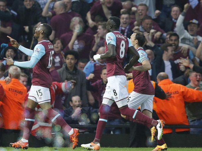 West Ham's Diafra Sakho, left, celebrates after scoring during the English Premier League soccer match between West Ham and Manchester United at Boleyn Ground stadium in London, Tuesday, May 10, 2016. (AP Photo/Frank Augstein)