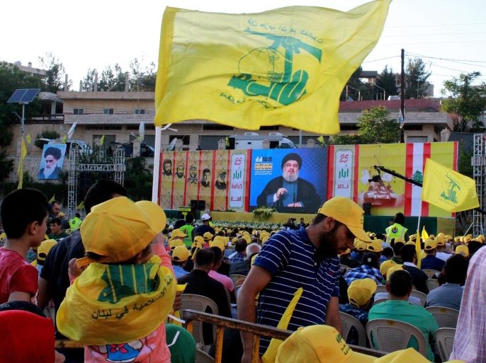 Supporters of Hezbollah listen to a televised speech by Hezbollah leader Hassan Nasrallah from an undisclosed location, during a rally to mark 'Resistance and Liberation Day', in Nabichit village, Bekaa valley, eastern Lebanon, 25 May 2016. On 25 May 2000 the Israeli army withdrew from areas of southern Lebanon after a conflict which lasted 15 years.