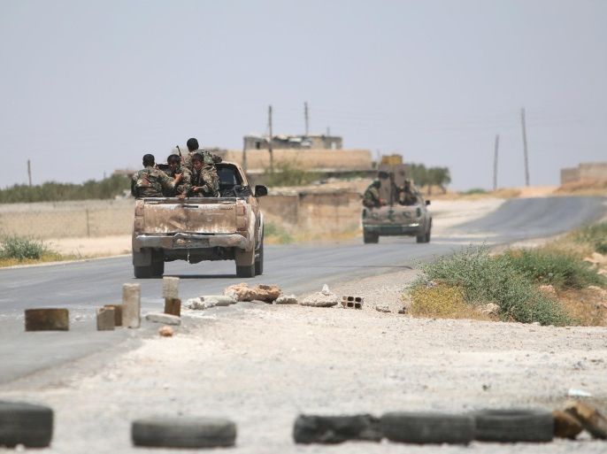 Syria Democratic Forces (SDF) ride vehicles along a road near Manbij, in Aleppo Governorate, Syria, June 25, 2016. REUTERS/Rodi Said
