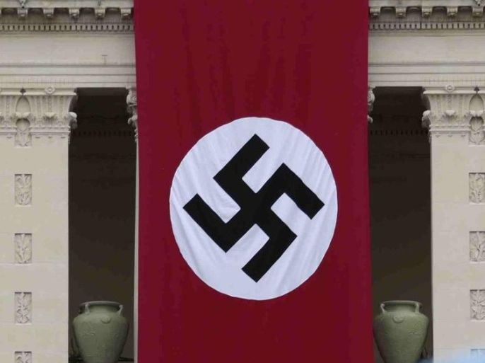 A Nazi swastika banner hangs on the facade of the Prefecture Palace in Nice which is being used as part of a movie set during the filming of a WWII film in the old city of Nice, France, September 29, 2015. The Prefecture released a statement on Monday to explain the Nazi banner's presence after strong public reaction. The Prefecture Palace will be the Excelsior hotel for the film "Un sac de billes", recreating events in Nice under the Occupation in World War Two. REUTERS/Eric Gaillard