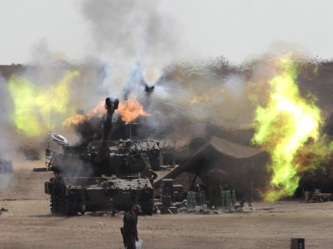 A picture rmade available on 15 August 2014 shows Israeli 155mm artillery guns firing from a base area in southern Israel into the Gaza Strip on 31 July 2014 during Operation Protective Edge. Israeli media reports on August 15 that Israel fired at least 32,000 artillery shells into the Gaza strip and that such massive shelling may have caused a large number of Palestinian civilian deaths.