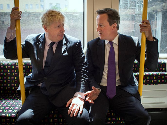 FILE PHOTO: Britain's Prime Minister David Cameron (R) and London Mayor Boris Johnson sit on an underground train as they head to Westminster after local election campaigning in Harrow, London May 12, 2014