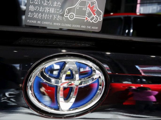 A visitor is reflected on a Toyota Motor Corp's Prius hybrid car at the company's showroom in Tokyo, Japan February 5, 2016. REUTERS/Toru Hanai/File Photo