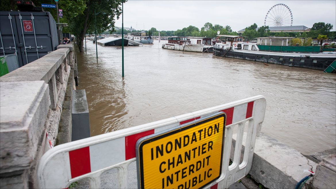 epa05344092 A sign reading 'Floods Work Zone Forbidden to Public', is displayed along the Seine river in Paris, France, 03 June 2016. Floods and heavy rain drenched about a quarter of the French territory over several days.  EPA/JEREMY LEMPIN
