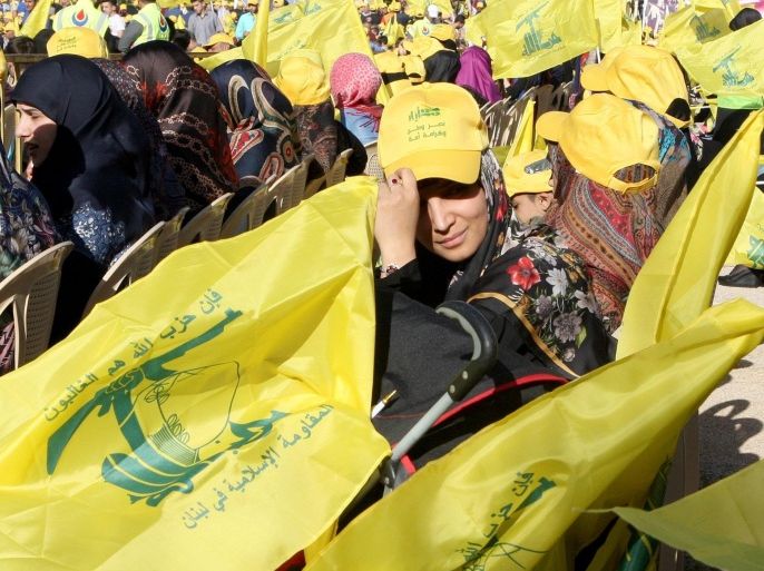 Supporters of Hezbollah wave party flags as they listen to a televised speech by Hezbollah leader Hassan Nasrallah from an undisclosed location, during a rally to mark 'Resistance and Liberation Day', in Nabichit village, Bekaa valley, eastern Lebanon, 25 May 2016. On 25 May 2000 the Israeli army withdrew from areas of southern Lebanon after a conflict which lasted 15 years.