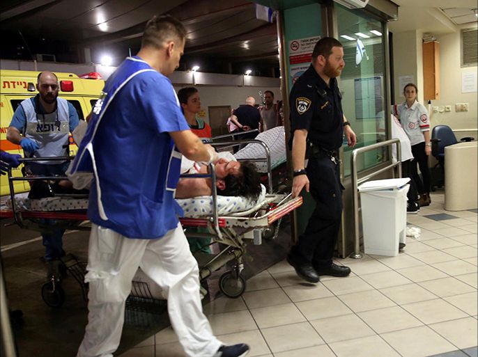 An injured man is taken into the emergency room following a shooting attack that took place in the center of Tel Aviv June 8, 2016.