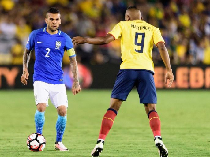 Jun 4, 2016; Pasadena, CA, USA; Brazil defender Dani Alves (2) moves the ball defended by Ecuador midfielder Fidel Martinez (9) during the second half during the group play stage of the 2016 Copa America Centenario at Rose Bowl Stadium. The game ended in a draw with a final score of 0-0. Mandatory Credit: Kelvin Kuo-USA TODAY Sports
