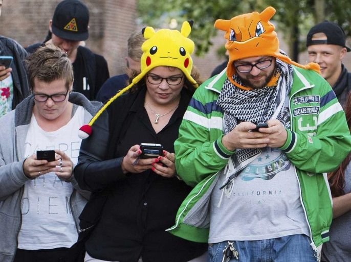 (FILE) A file picture dated 11 July 2016 shows people playing the new game 'Pokemon Go' on their smartphone in Leerdam, The Netherlands. According to reports, shares of Japanese multinational consumer electronics and software company Nintendo soared by 16 percent at the Tokyo Stock Exchange on 14 July 2016, given to the success of its new smartphone game 'Pokemon Go.' The shares of the company, which is headquartered in Kyoto, Japan, reached 244 US dollar during the first half of the trading day at the Tokyo exchange, media added. Pokemon Go, a Global Positioning System (GPS) based augmented reality mobile game, launched first on 06 July in the US.
