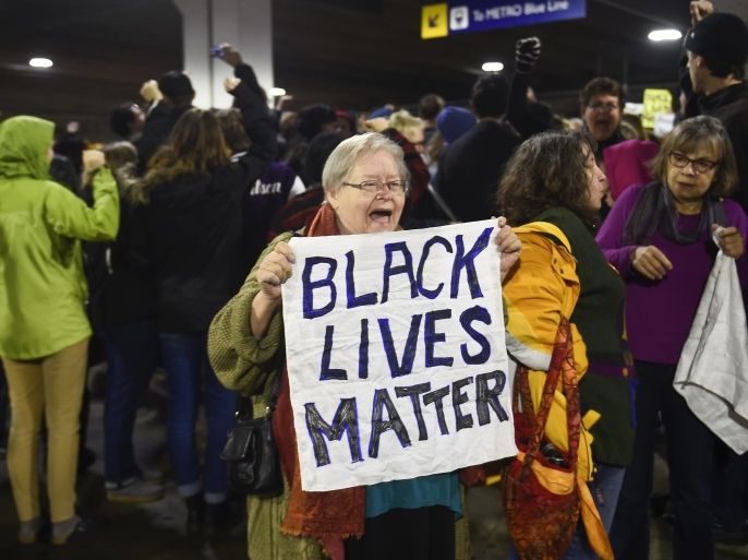Black Lives Matter protesters chant slogans at the Mall of America light rail station in Bloomington, Minnesota December 23, 2015. Demonstrations by Black Lives Matter to protest police killings of black men took place in Minnesota and California on Wednesday, a day the activist group dubbed "Black Xmas" to show it could impact the economy on one of the busiest shopping days of the year. REUTERS/Craig Lassig