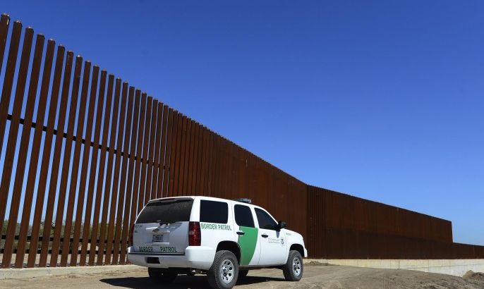 A United States Border Patrol vehicle stands alone next to a stretch of fence along the Rio Grande River near McAllen, Texas, USA, 26 February 2013. The nearly 2,000 mile (3,200 km) United States-Mexico border is considered to be the most frequently crossed international border in the world.