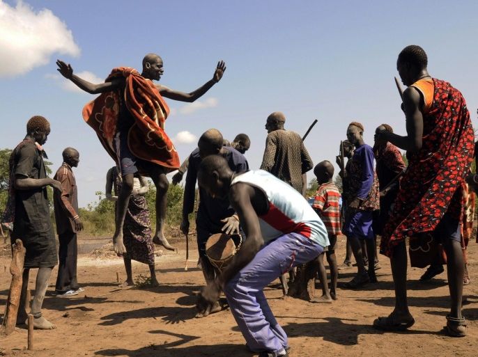 Cattle keepers from the Dinka tribe perform a traditional dance after a prayer session for peace and good health along the route to Rajaf Payam outside the capital Juba October 18, 2014. Picture taken October 18, 2014. REUTERS/Jok Solomon (SOUTH SUDAN - Tags: SOCIETY AGRICULTURE ANIMALS TPX IMAGES OF THE DAY)