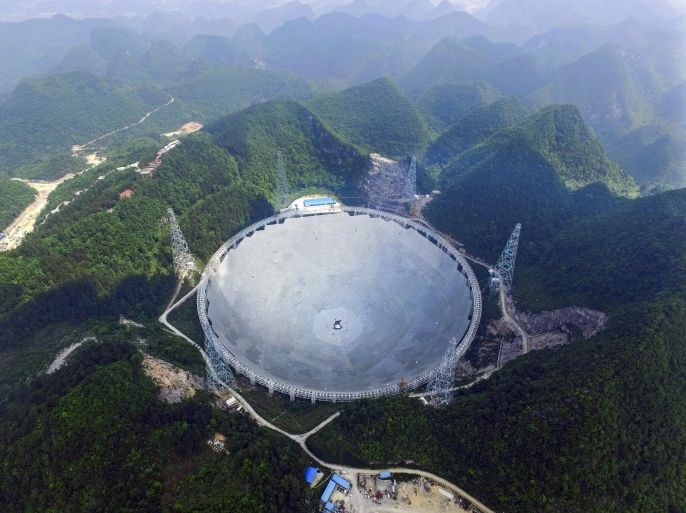 A picture made available on 23 May 2016 shows a general view on the five-hundred-meter Aperture Spherical radio Telescope (FAST) under construction in the remote Pingtang county, southwest China's Guizhou province, 07 May 2016. The project, one of China's nine most important scientific research facilities, will be the world's largest radio telescope. The 250,000 square meters of reflective surface will be completed by May 30. EPA/STR CHINA OUT