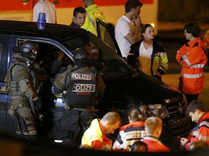 Special force police officers stand in front of a car near the Olympia shopping mall, following a shooting rampage at the mall in Munich, Germany July 23, 2016. REUTERS/Michael Dalder