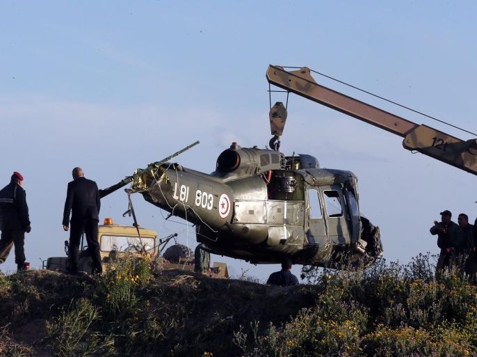 Tunisian soldiers remove the remains of a crashed helicopter near an air base in the suburb of Aouina, Tunis, Tunisia, 05 April 2013. According to the Tunisian defence ministry, two were injured when the helicopter made a crash landing.