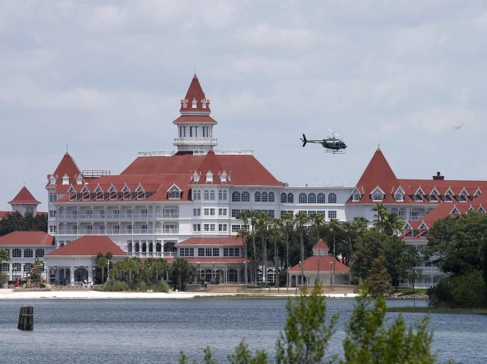 A Florida Fish and Wildlife Conservation Commission helicopter flies over the Seven Seas lagoon at Walt Disney World resort after an alligator dragged a two-year-old boy into the water in Orlando, Florida, U.S. June 15, 2016. REUTERS/Adrees Latif