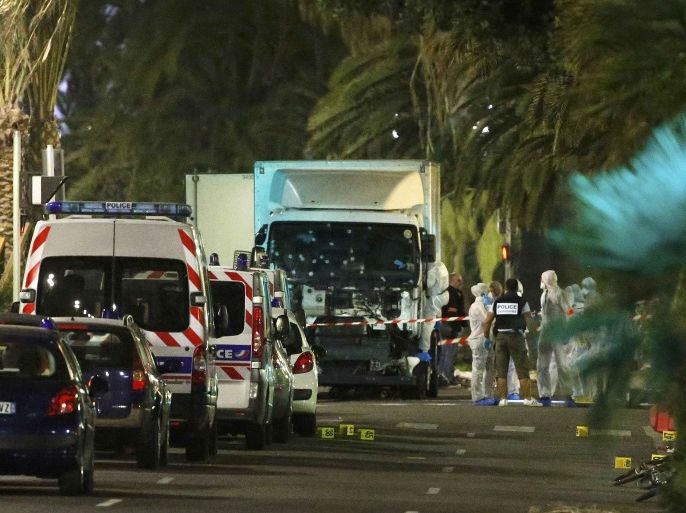 French police forces and forensic officers stand next to a truck July 15, 2016 that ran into a crowd celebrating the Bastille Day national holiday on the Promenade des Anglais killing at least 60 people in Nice, France, July 14. REUTERS/Eric Gaillard