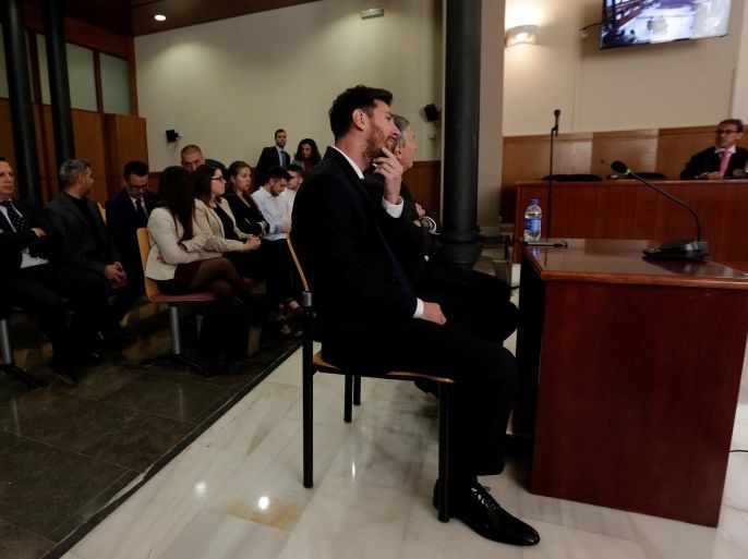 Barcelona's Argentine soccer player Lionel Messi sits in court with his father Jorge Horacio Messi during their trial for tax fraud in Barcelona, Spain, June 2, 2016. REUTERS/Alberto Estevez/POOL