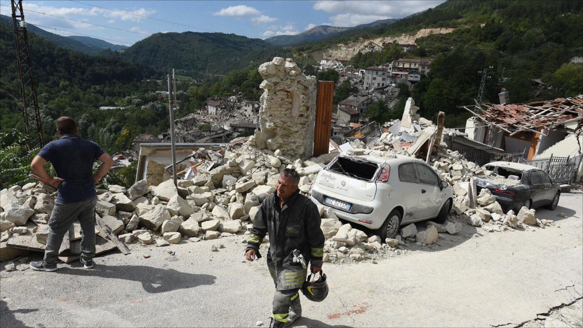 epa05508359 A member of a search and rescue team  walks at a street amid collapsed and damaged houses in Pescara del Tronto, central Italy, 24 August 2016, following a 6.2 magnitude earthquake, according to the United States Geological Survey (USGS), that struck at around 3:30 am local time (1:30 am GMT). The quake was felt across a broad section of central Italy, in Umbria, Lazio and Marche Regions, including the capital Rome where people in homes in the historic center felt a long swaying followed by aftershocks. According to reports at least 37 people died in the quake.  EPA/CROCCHIONI