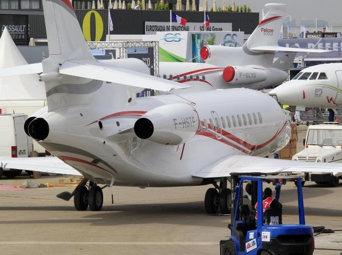 A Dassault Aviation Falcon 7X is taxied to the static exhibition area, three days before the opening of the 50th Paris Air Show, at Le Bourget Airport near Paris June 14, 2013. The Paris Air Show runs from June 17 to 23. REUTERS/Pascal Rossignol (FRANCE - Tags: BUSINESS TRANSPORT)