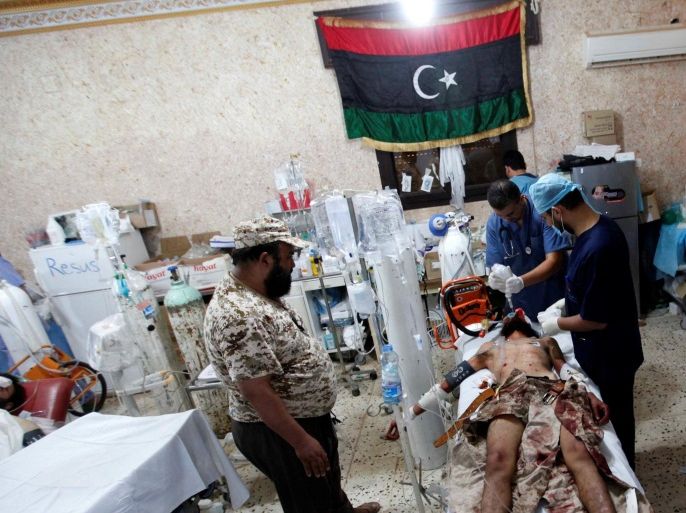 A wounded fighter from Libyan forces allied with the U.N.-backed government, who was injured during a battle with Islamic State fighters, receives treatment in a field hospital in Sirte, Libya August 16, 2016. Picture taken August 16, 2016. REUTERS/Ismail Zitouny