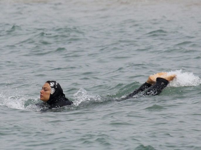 A Muslim woman wears a burkini, a swimsuit that leaves only the face, hands and feet exposed, as she swims in the Mediterranean Sea in Marseille, France, August 17, 2016. REUTERS/Stringer