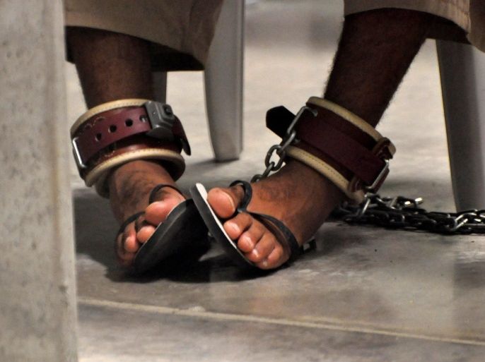 FILE PHOTO - In this photo, reviewed by a U.S. Department of Defense official, a Guantanamo detainee's feet are shackled to the floor as he attends a "Life Skills" class inside the Camp 6 high-security detention facility at Guantanamo Bay U.S. Naval Base April 27, 2010. REUTERS/Michelle Shephard/Pool/File Photo