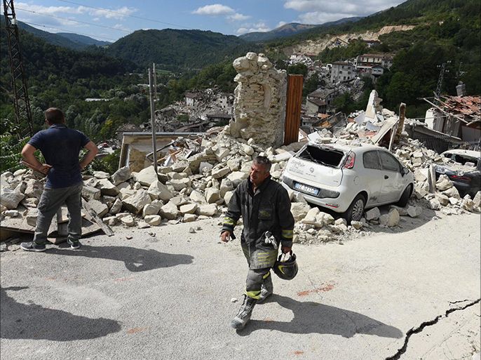 epa05508359 A member of a search and rescue team walks at a street amid collapsed and damaged houses in Pescara del Tronto, central Italy, 24 August 2016, following a 6.2 magnitude earthquake, according to the United States Geological Survey (USGS), that struck at around 3:30 am local time (1:30 am GMT). The quake was felt across a broad section of central Italy, in Umbria, Lazio and Marche Regions, including the capital Rome where people in homes in the historic center felt a long swaying followed by aftershocks. According to reports at least 37 people died in the quake. EPA/CROCCHIONI