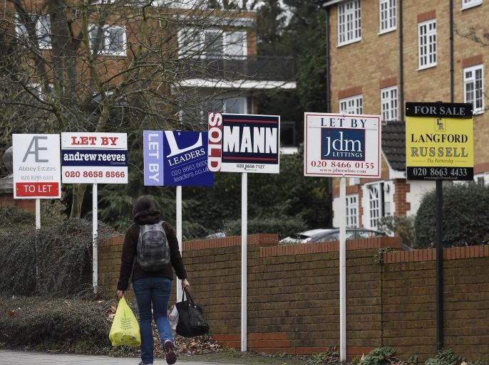 A woman walks past by 'To Let' or 'Sold' signs in south-east London, Britain, 31 January 2016. House prices have rocketed in the outskirts of the capital as buyers move further out. The housing property market has seen rises up the 20 per cent such in the boroughs of Newham or Waltham Forest in the last year alone, while boroughs such as Westminster had a very modest increase.