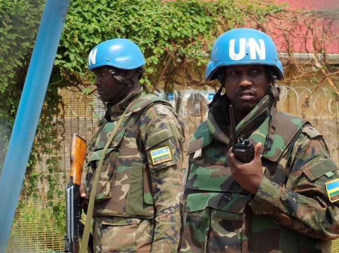 Rwandan peacekeepers serving in the United Nations Mission in South Sudan (UNMISS) stand guard inside their compound as members of the civil society and political parties participate in a protest against foreign military deployment to South Sudan in the capital Juba, July 20, 2016. REUTERS/Stringer FOR EDITORIAL USE ONLY. NO RESALES. NO ARCHIVES.