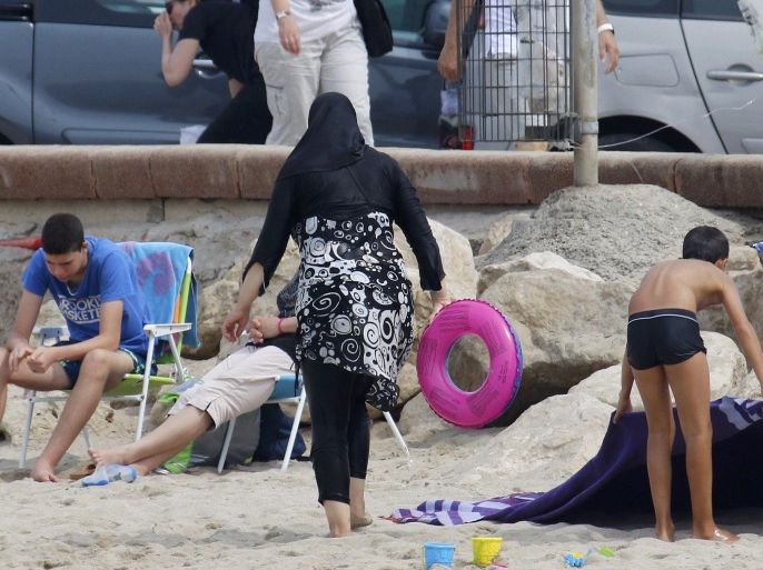 A Muslim woman wears a burkini, a swimsuit that leaves only the face, hands and feet exposed, on a beach in Marseille, France, August 17, 2016. REUTERS/Stringer