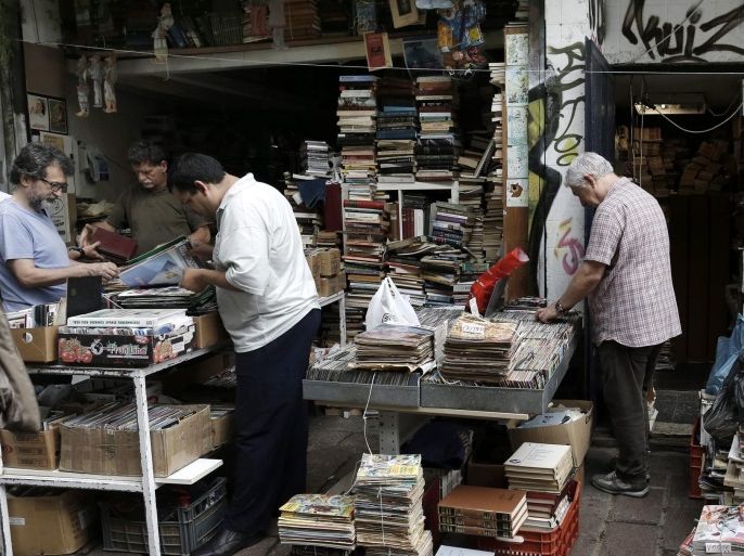 People pick out old books and magazines at an antique shop in central Athens, Greece, 22 June 2015. The negotiations between the Greek government and the creditors will peak on later in the day in Brussels with the view to bridging the differences in taxation and early pensions and reaching an agreement.