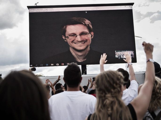 Festival-goers greet whistleblower Edward Snowden (on screen) during a via live stream interview with The Yes Men during Roskilde Festival in Roskilde, Denmark, 28 June 2016. The festival runs from 25 June to 02 July. EPA/MATHIAS LOEVGREEN BOJESEN DENMARK OUT