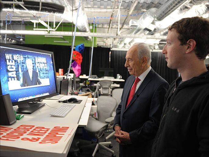 epa03134627 A photograph supplied by the Israeli Government Press Office (GPO) shows Israeli President Shimon Peres (L) with Mark Zuckerberg, the founder of Facebook, as they meet in Facebook's headquarters in Palo Alto, California, USA, 06 March 2012. Both men launched the Peres international Facebook page for Peace and Zuckerberg was the first to click the 'like' button. EPA/MOSHE MILNER/HANDOUT ISRAELI SUBSCRIBERS MUST CREDIT GPO EDITORIAL USE ONLY NO SALES