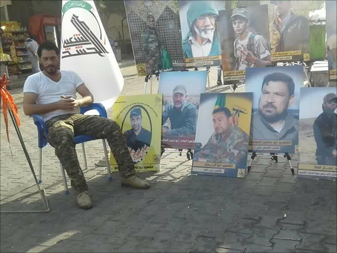 صور في شوارع الكرادة لعدد من قتلى الحشد الشعبي الذين سقطوا في المعارك مؤخرا ضد تنظيم الدولة (الجزيرة نت)