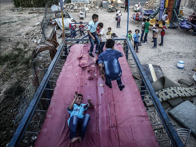 epaselect epa05538398 Syrian children playing on a trampoline during the second day of Eid Al Adha in Douma, outside Damascus, Syria, 13 September 2016. Eid al-Adha is the holiest of the two Muslims holidays celebrated each year, it marks the yearly Muslim pilgrimage (Hajj) to visit Mecca, the holiest place in Islam. Muslims slaughter a sacrificial animal and split the meat into three parts, one for the family, one for friends and relatives, and one for the poor and needy. EPA/MOHAMMED BADRA