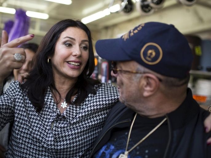 Israel's Culture Minister, Miri Regev (L), a member of Prime Minister Benjamin Netanyahu's Likud party and former army spokeswoman, speaks with a supporter during an election campaign stop at a market in Netanya, north of Tel Aviv, Israel, in this February 25, 2015 file picture. REUTERS/Amir Cohen/Files