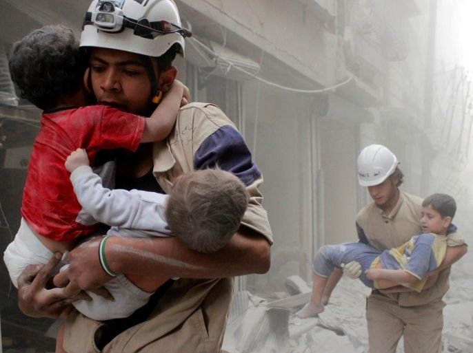 Members of the Civil Defence rescue children after what activists said was an air strike by forces loyal to Syria's President Bashar al-Assad in al-Shaar neighbourhood of Aleppo, Syria June 2, 2014. REUTERS/Sultan Kitaz/File Photo     TPX IMAGES OF THE DAY
