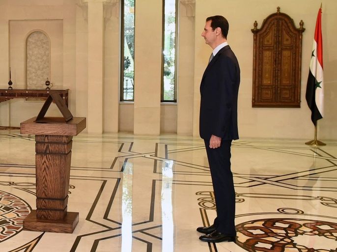 A handout photo made available by Syria's Arab News Agency, SANA, shows Syrian Prime Minister, Wael Nader al-Halaqi, (L) taking the oath before Syrian President Bashar Assad (R) in Damascus, Syria, 31 August 2014. The newly-formed Cabinet was sworn in before Syrian President Bashar Assad. The new government was formed on 27 August 2014 and brought in 11 new ministers. Reports state that most of the old important ministers retained their posts, including the defense, f