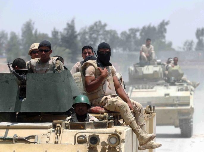 A picture made available 23 July 2015 shows members of the Egyptian armed forces in armoured vehicles patrolling a street near the town of Sheikh Zuweid, in the north of Sinai, Egypt, 13 July 2015. According to local reports 23 July four members of the Egyptian armed forces were killed when a roadside bomb exploded on a road near Rafah, to the east of Sheikh Zuweid. No group has claimed responsibility, however, hundreds of the armed forces have been killed as unrest con