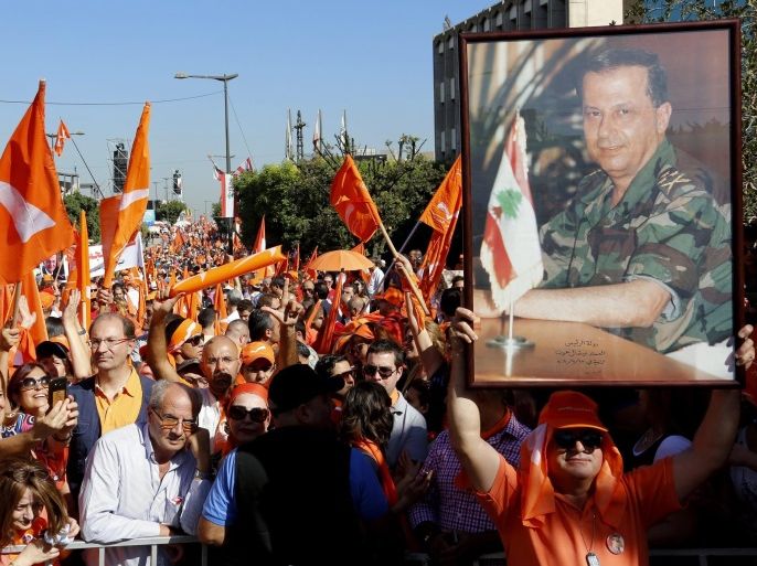 Lebanese protesters hold photo depicting leader of the Free Patriotic Movement, General Michel Aoun, during a demonstration on the street leading to the Presidential Palace, east of Beirut, Lebanon, 16 October 2016. According to reports, thousands of supporters of the Free Patriotic Movement gathered in Baabda road to mark the 26th anniversary when Syrian warplanes bombed the presidential palace in Baabda on 13 October 1990 forcing the then Prime Minister Michel Aoun to